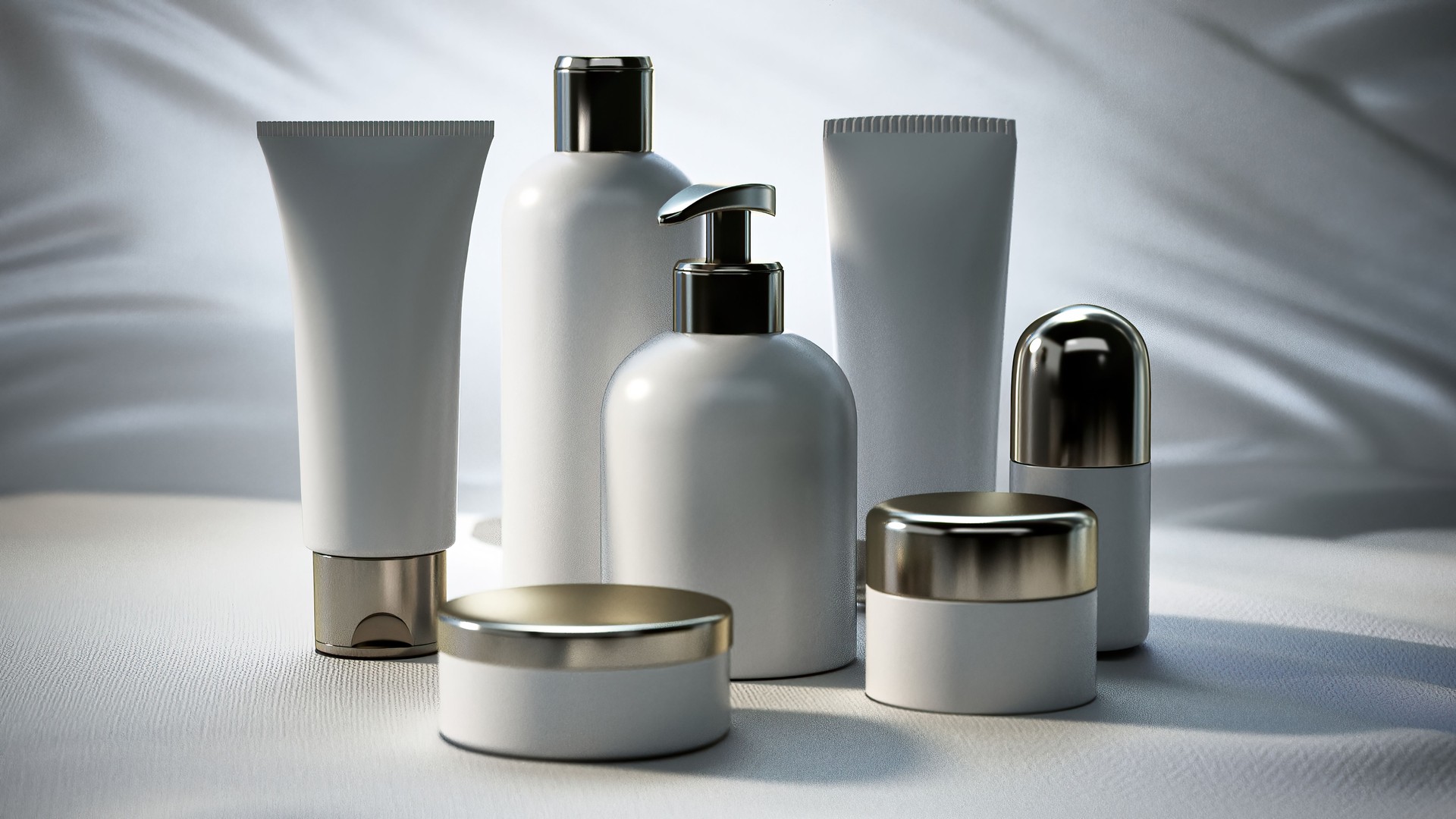 White Cosmetic Products Bottles With Silver Caps on White Fabric